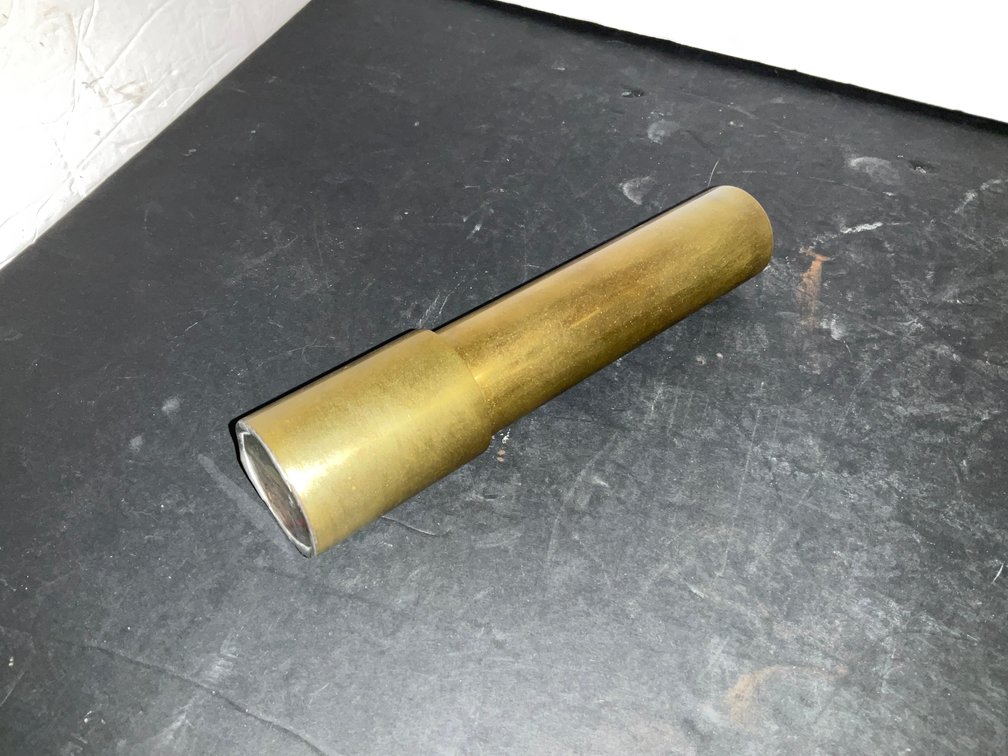 Cylindrical brass kaleidoscope with colored bead cell - Living Room Main Level
