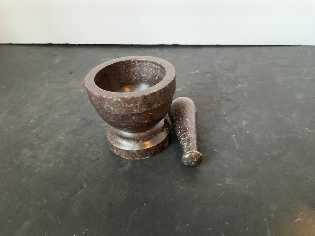 Polished dark speckled stone mortar & pestle - Living Room Main Level