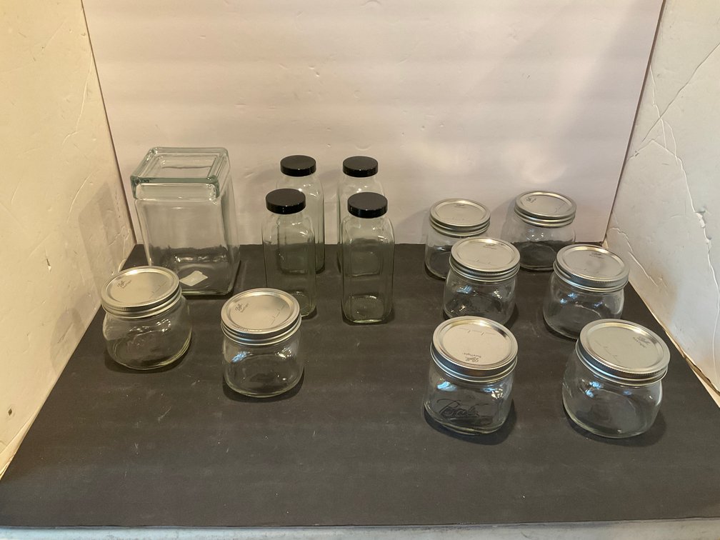 Grouping of clear glass jars, bottles & canister - Kitchen Main Level