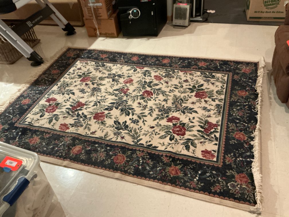 Floral area rug with dark border & fringe 64” wide - Basement