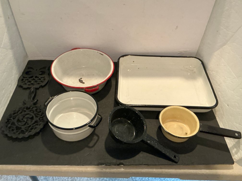 Grouping of enamelware cookware & cast iron trivets - Basement