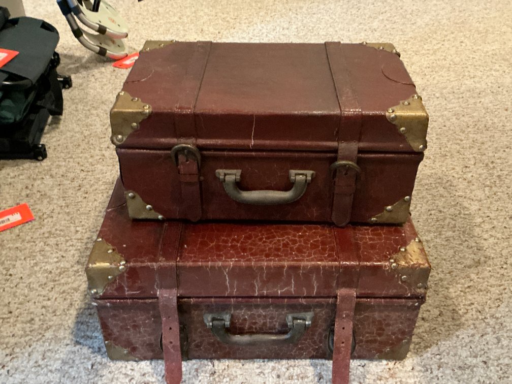 Pair of reddish-brown suitcase trunks with strap closures - Basement