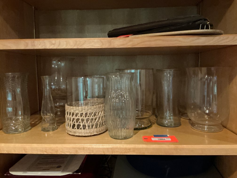 Grouping of clear glass vases & hurricane vessels - Basement