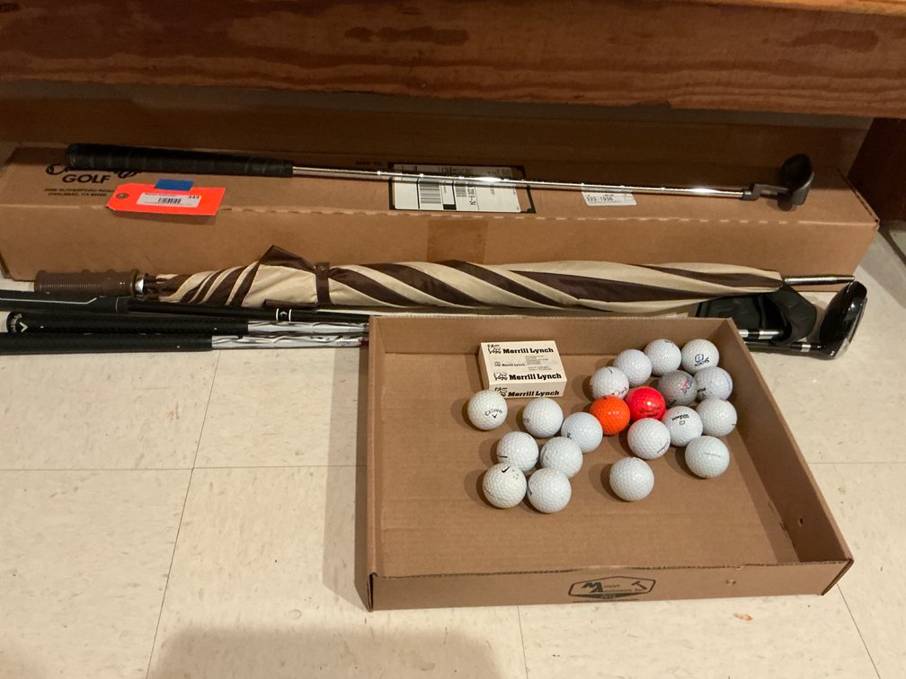 Grouping of golf clubs with balls & umbrella - Basement