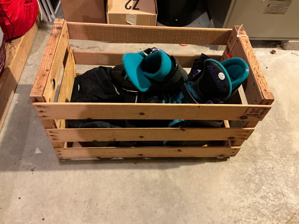 Wooden crate with inline skates, ice skates & pads - Basement