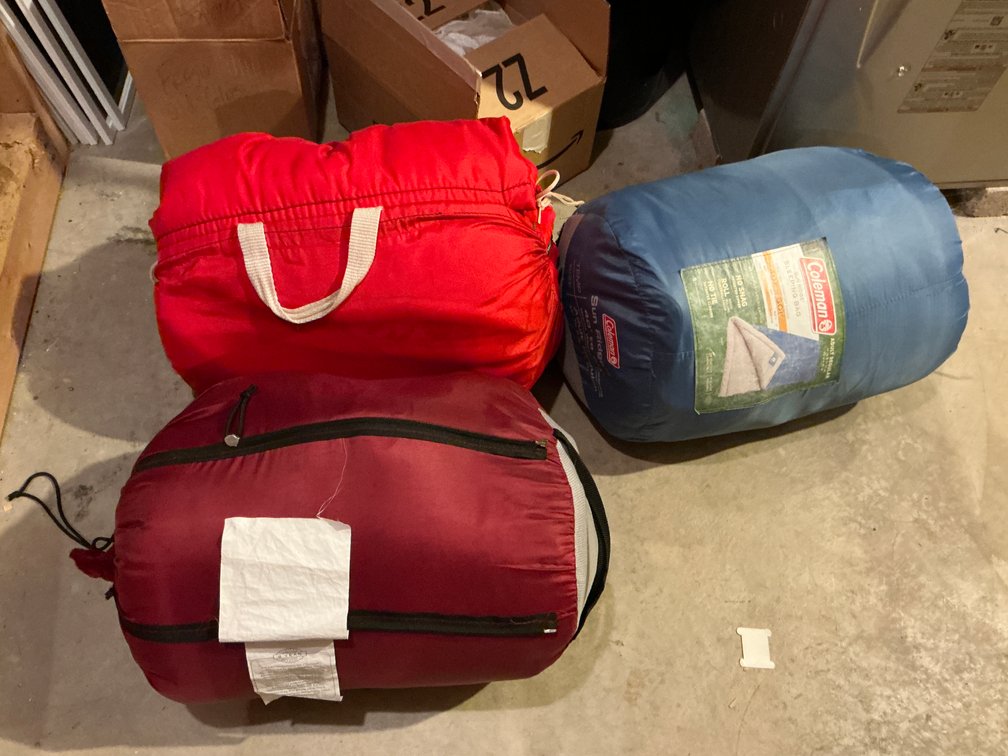 Grouping of 3 sleeping bags in blue, maroon & red - Basement