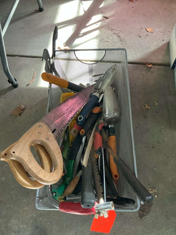 Assorted garden hand tools & saws in wire basket - Garage