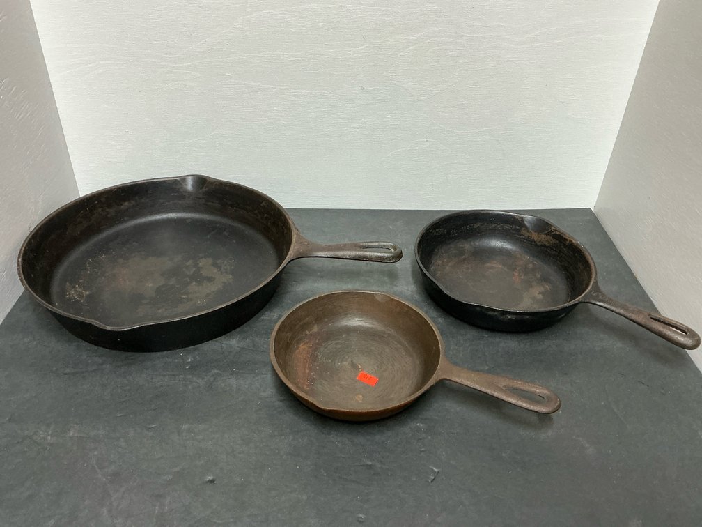 Grouping of 3 cast iron skillets with pour spouts