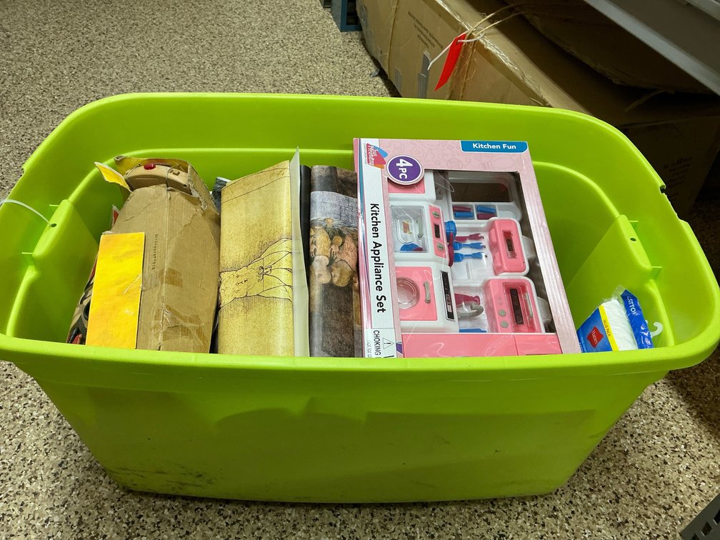 Green plastic tote with assorted toys & board games