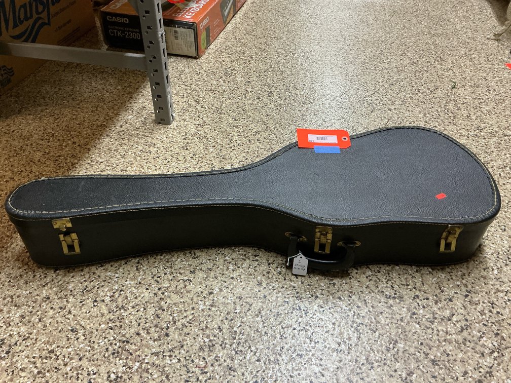 Acoustic guitar with black hardshell case