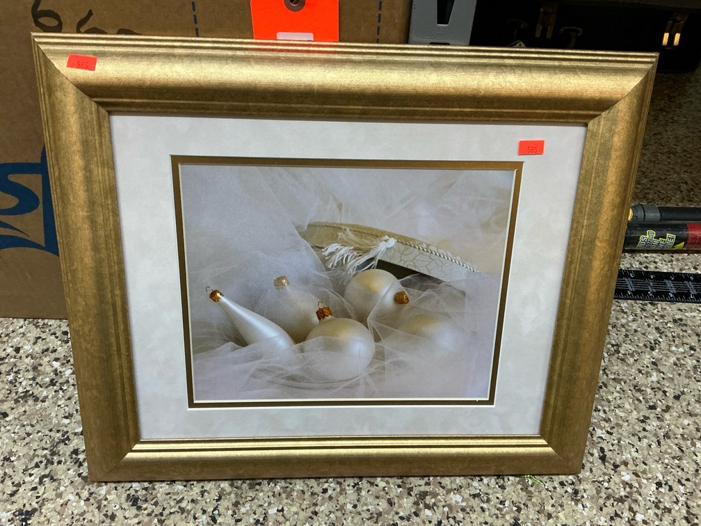 Framed photograph of white ornaments in gold-tone frame