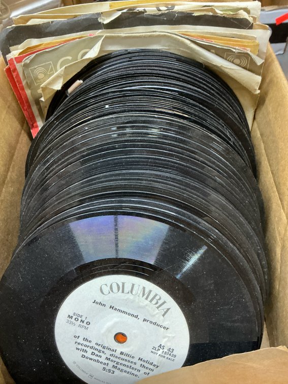 Grouping of vinyl records with cardboard box