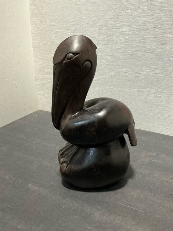 Carved dark hardwood pelican sculpture