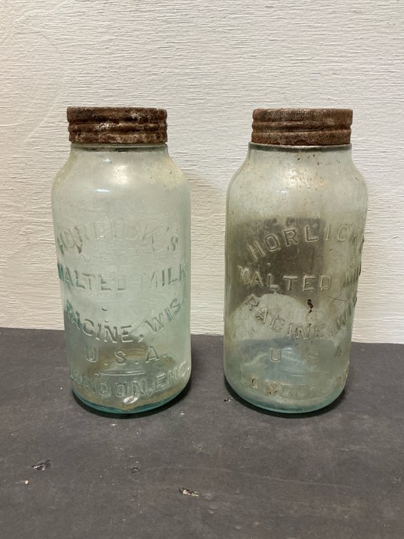 Pair of Horlick's aqua glass jars with metal lids