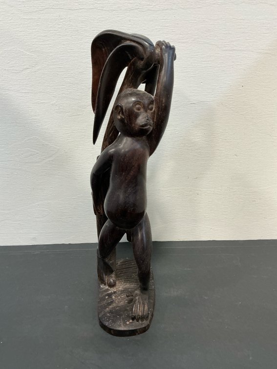 Carved dark wood standing monkey sculpture