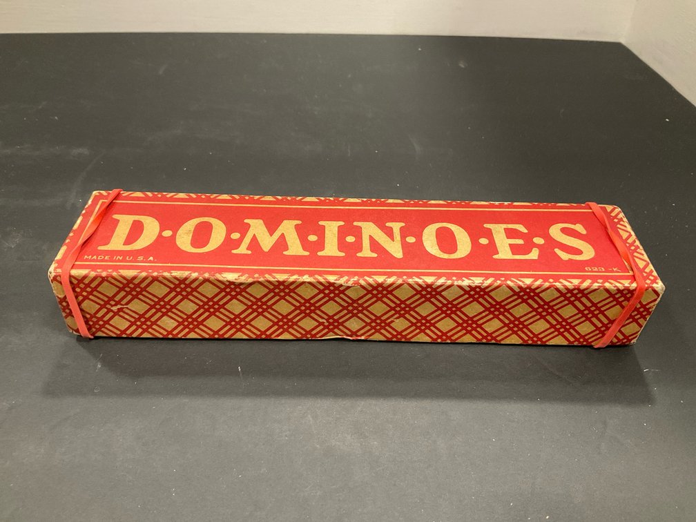 Dominoes game set with embossed black tiles
