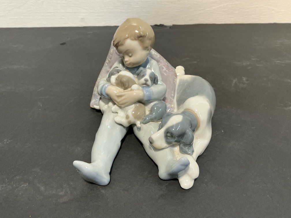 Lladró porcelain figurine of boy with puppies