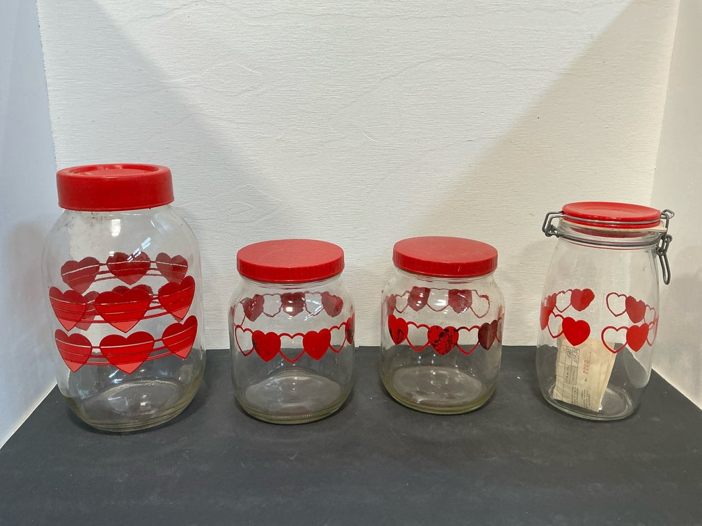 Glass canisters with red heart motifs