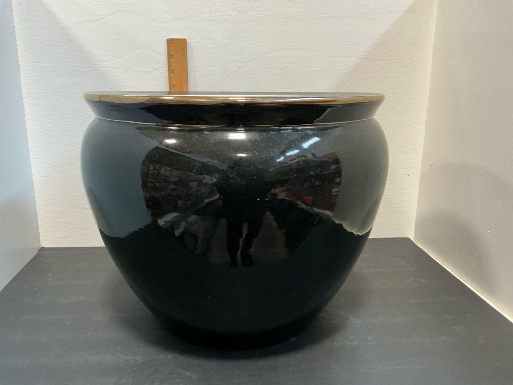 Black ceramic fishbowl planter with goldfish interior