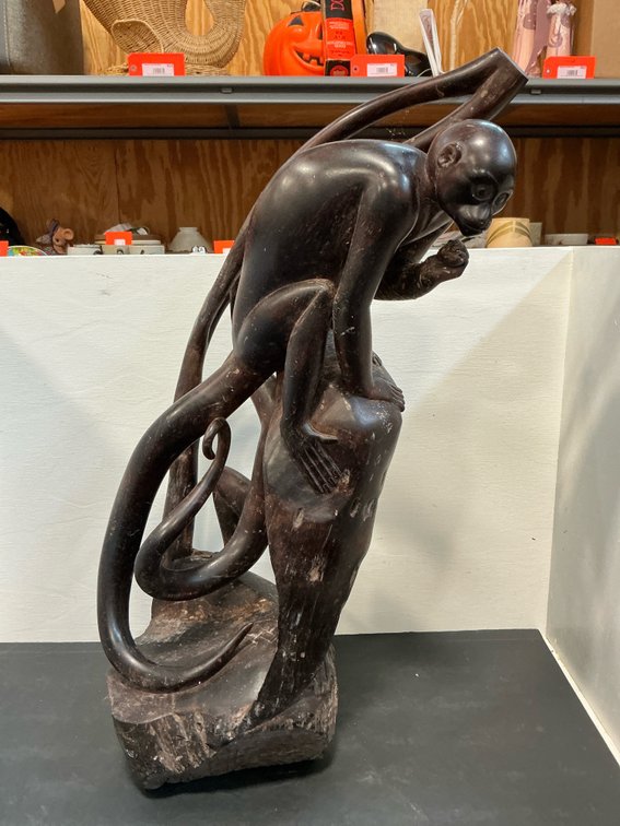 Carved dark wood climbing monkeys sculpture