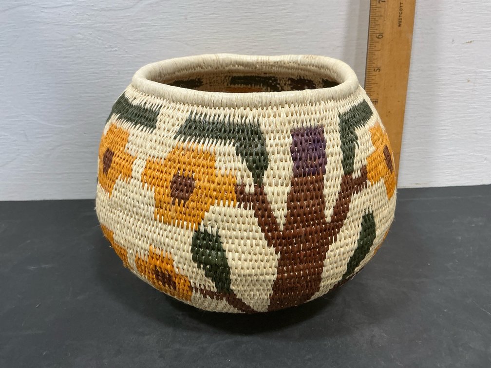 Coiled woven basket with floral motif