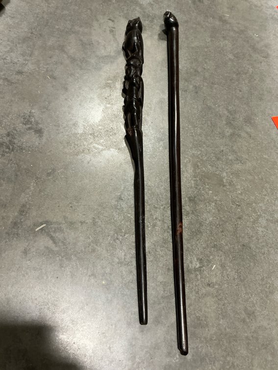 2 carved dark wood figural walking sticks
