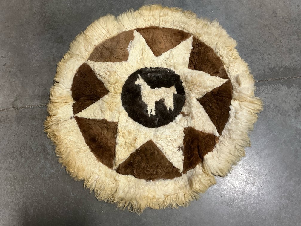 Circular patchwork fur rug with llama motif, 33 in