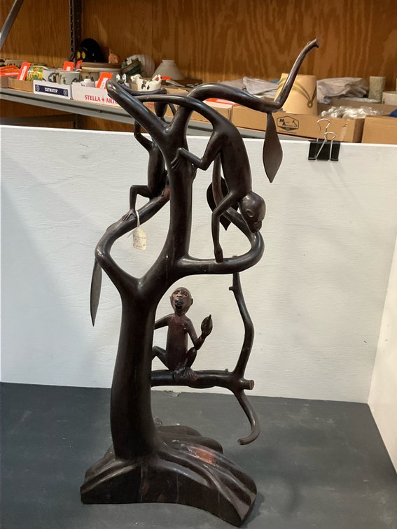 Carved dark wood monkey tree sculpture