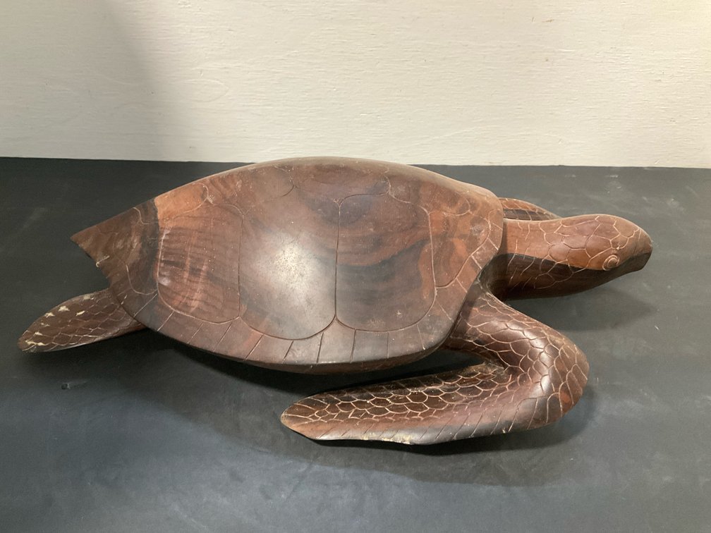Carved wood sea turtle sculpture in swimming pose