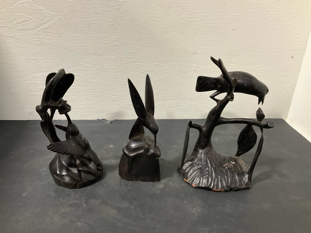 Hand-carved dark wood bird sculptures