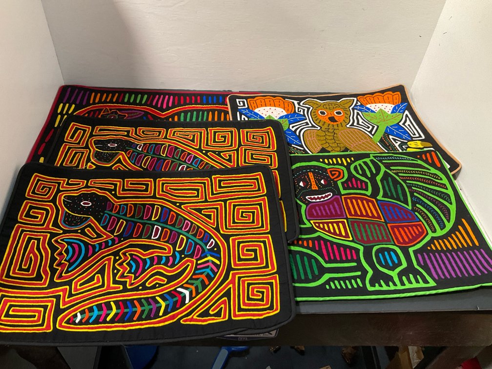Reverse applique mola placemats with animal designs