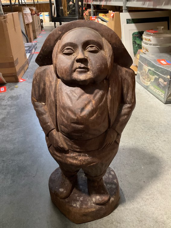 Carved dark wood stout figure with hat