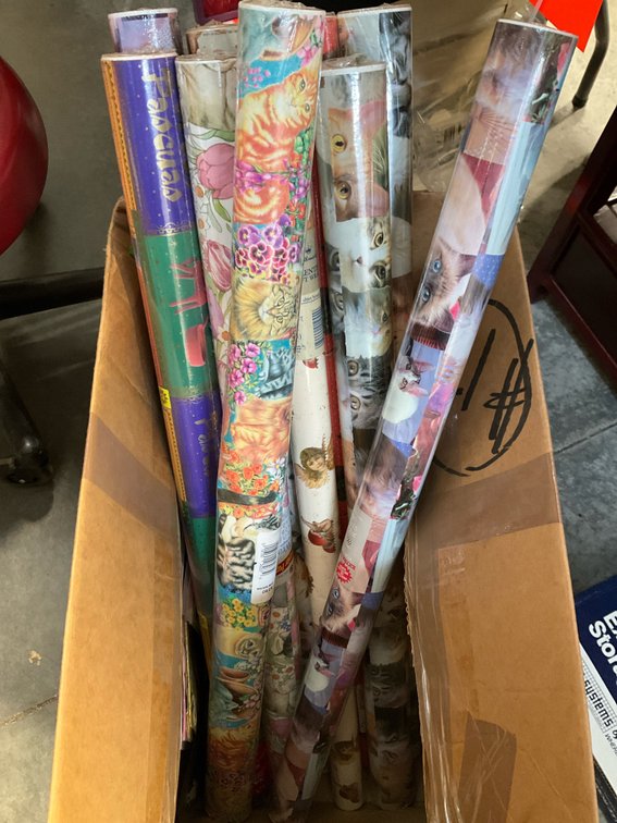 Assorted gift wrapping paper rolls & packaging items
