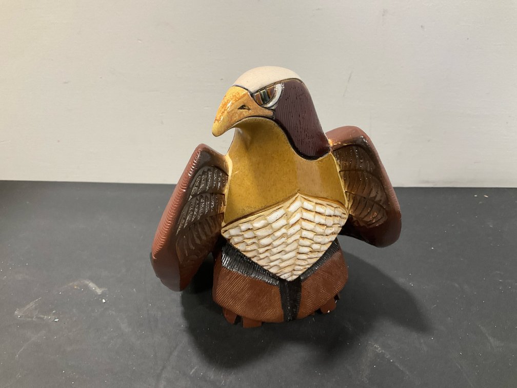 Carved ceramic eagle figurine with glazed accents