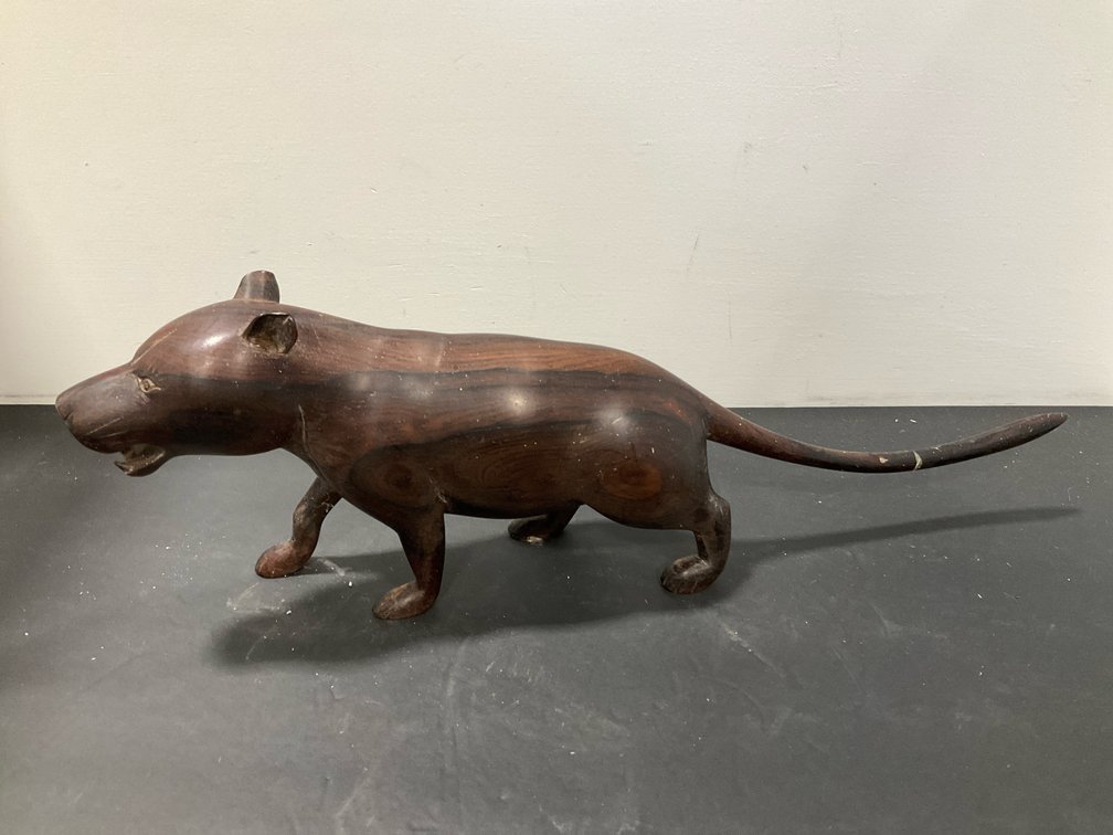 Carved hardwood prowling feline figurine