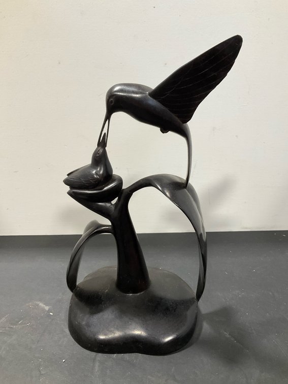 Carved dark wood hummingbird sculpture