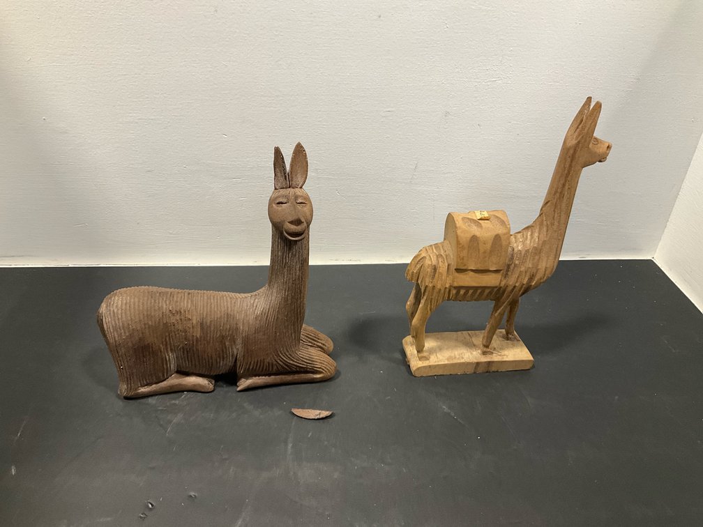 Pair of carved wooden llama figurines