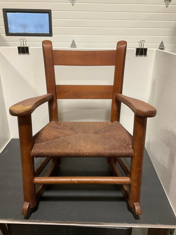 Child-size wooden rocking chair with woven rush seat