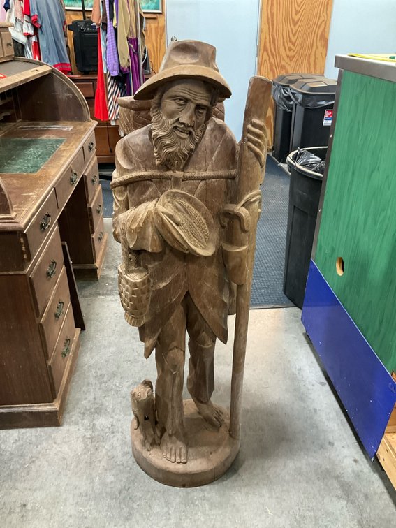Carved wood statue of bearded man with dog & staff