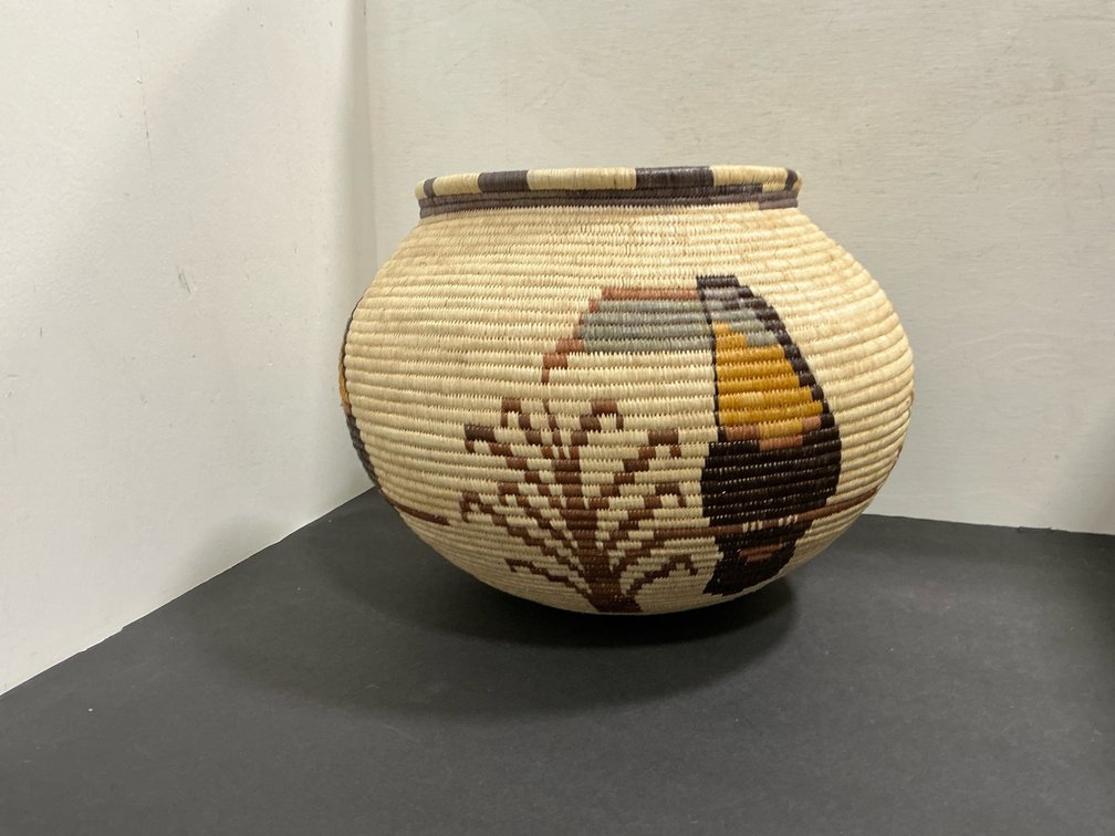 Grouping of coiled woven pictorial baskets