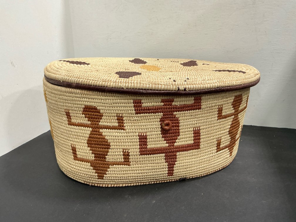 Oval coiled woven lidded basket with lizard motifs