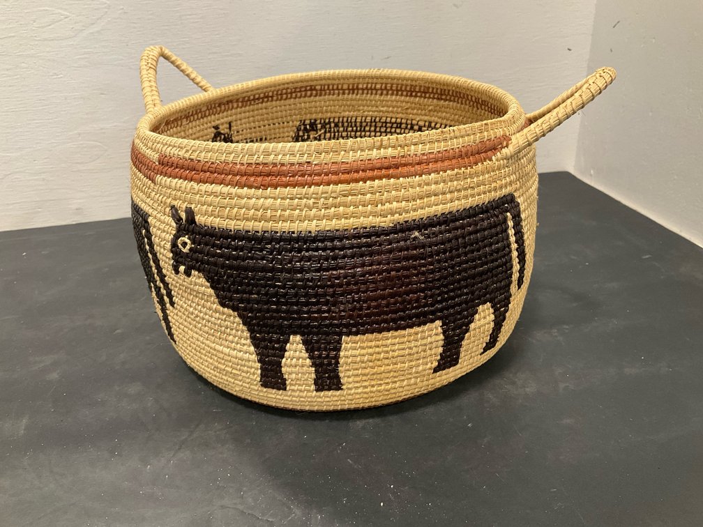 Coiled woven fiber basket with handles & cow motif