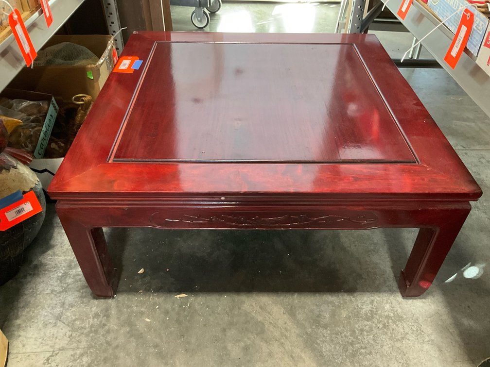 Asian-style square wood coffee table with carved apron