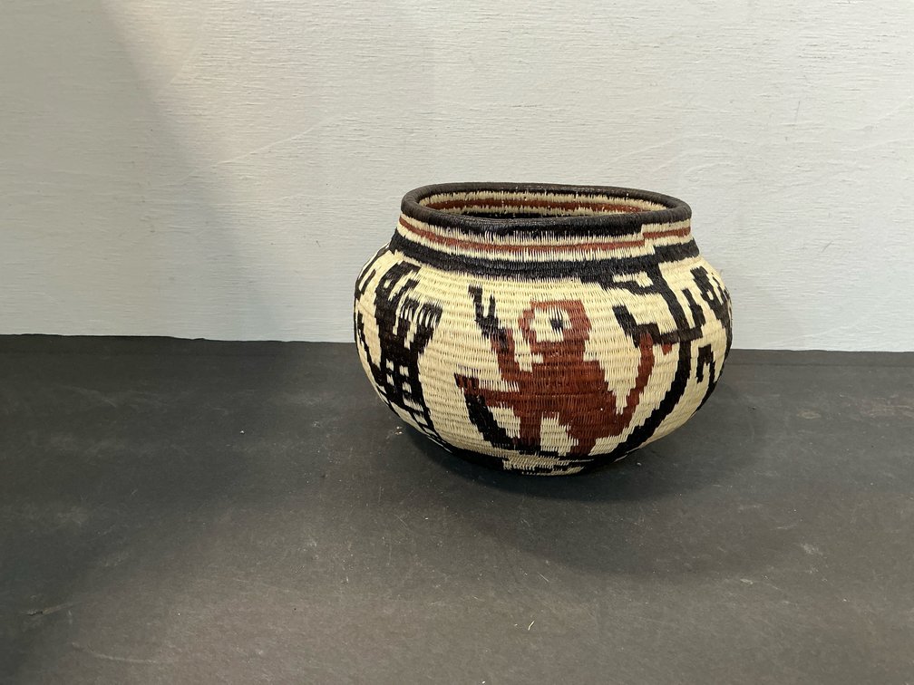Coiled woven fiber basket with animal motifs