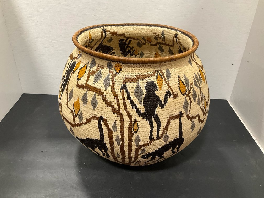Coiled woven basket with monkey & tree motifs