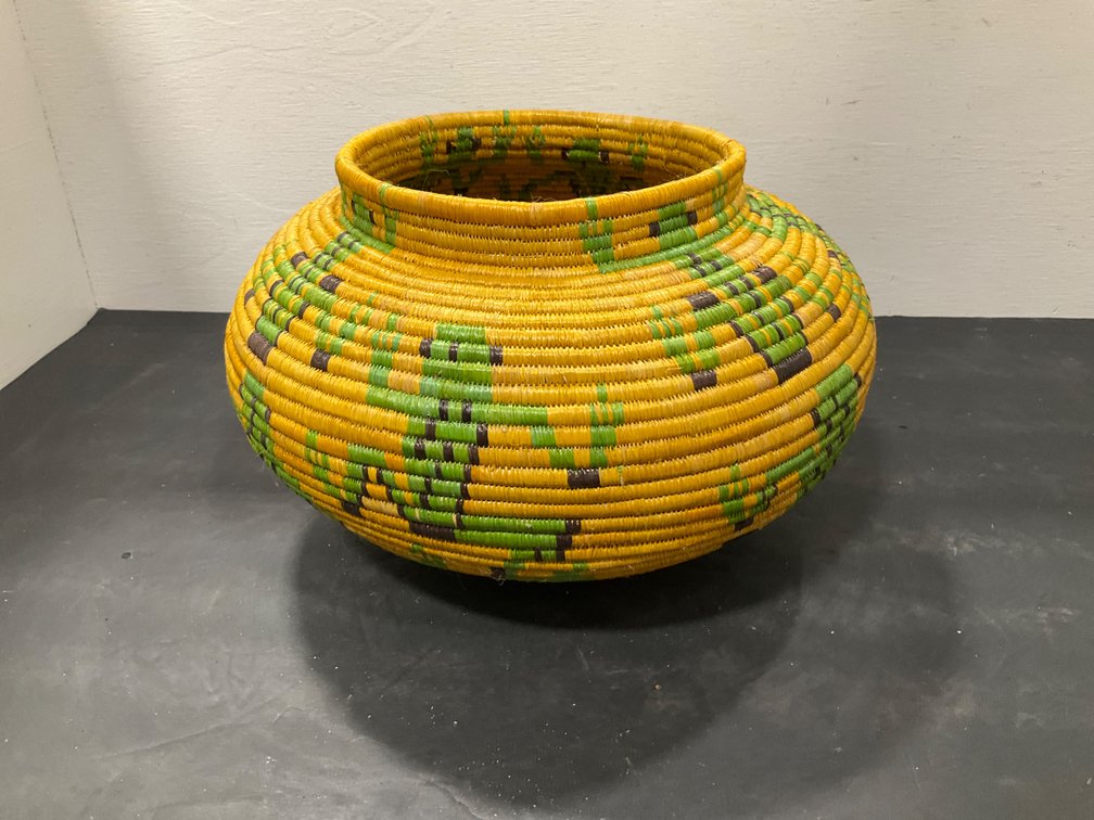 Yellow coiled woven basket with geometric design