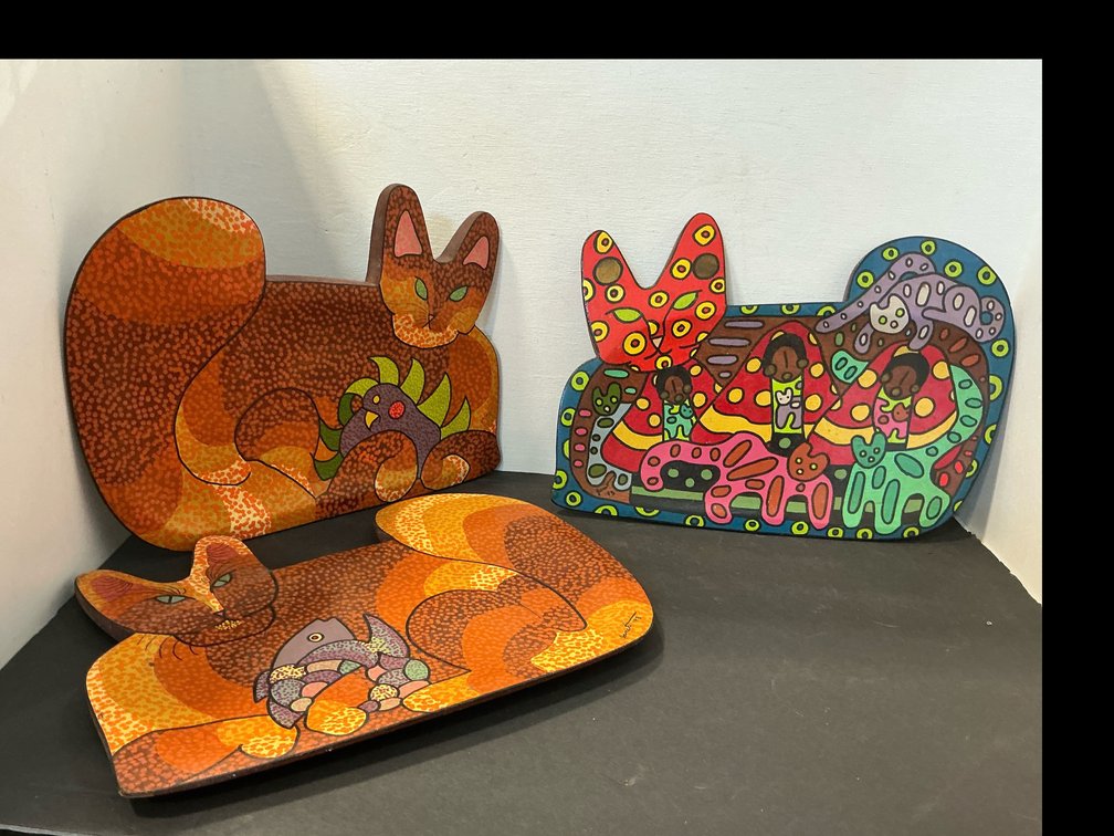 Painted cat-shaped wooden plaques