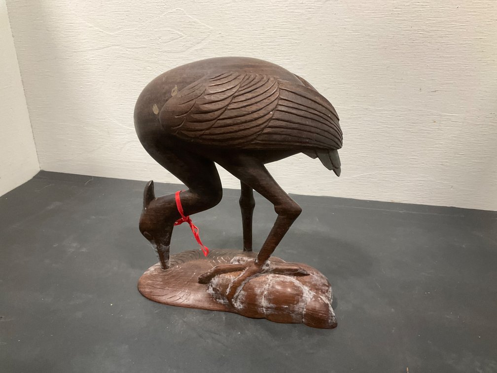 Carved dark wood wading bird sculpture