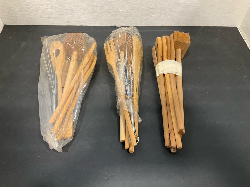 Bundles of wooden kitchen utensils & wire whisks