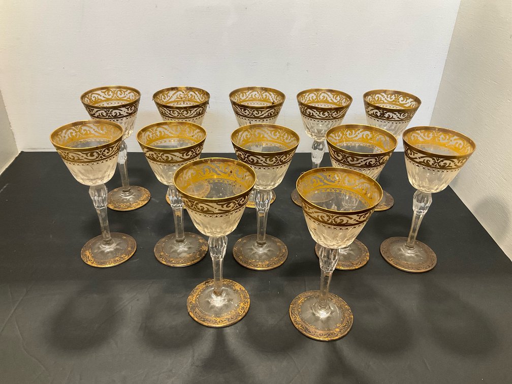 Set of cut crystal goblets with gold gilt rims